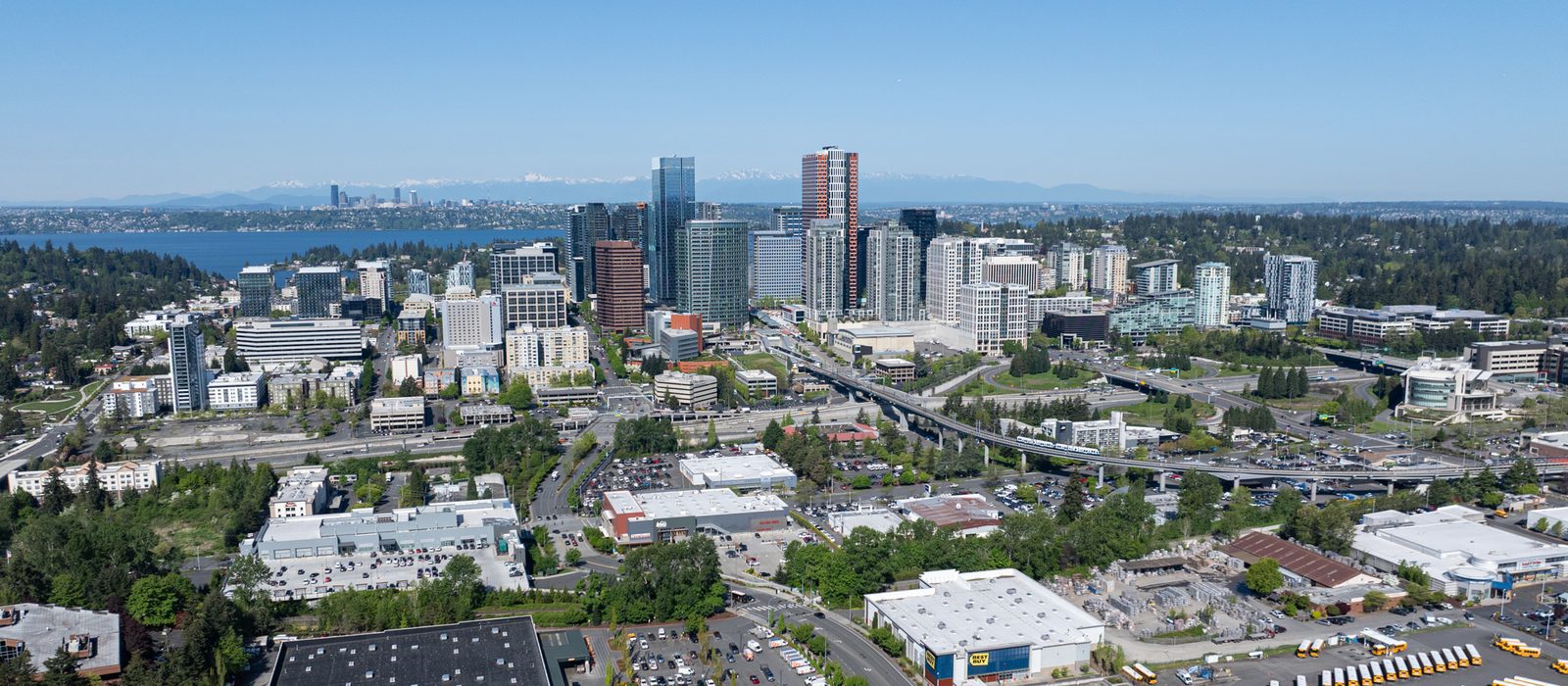 Aerial view of downtown Bellevue with the Cascade Mountains in the distance